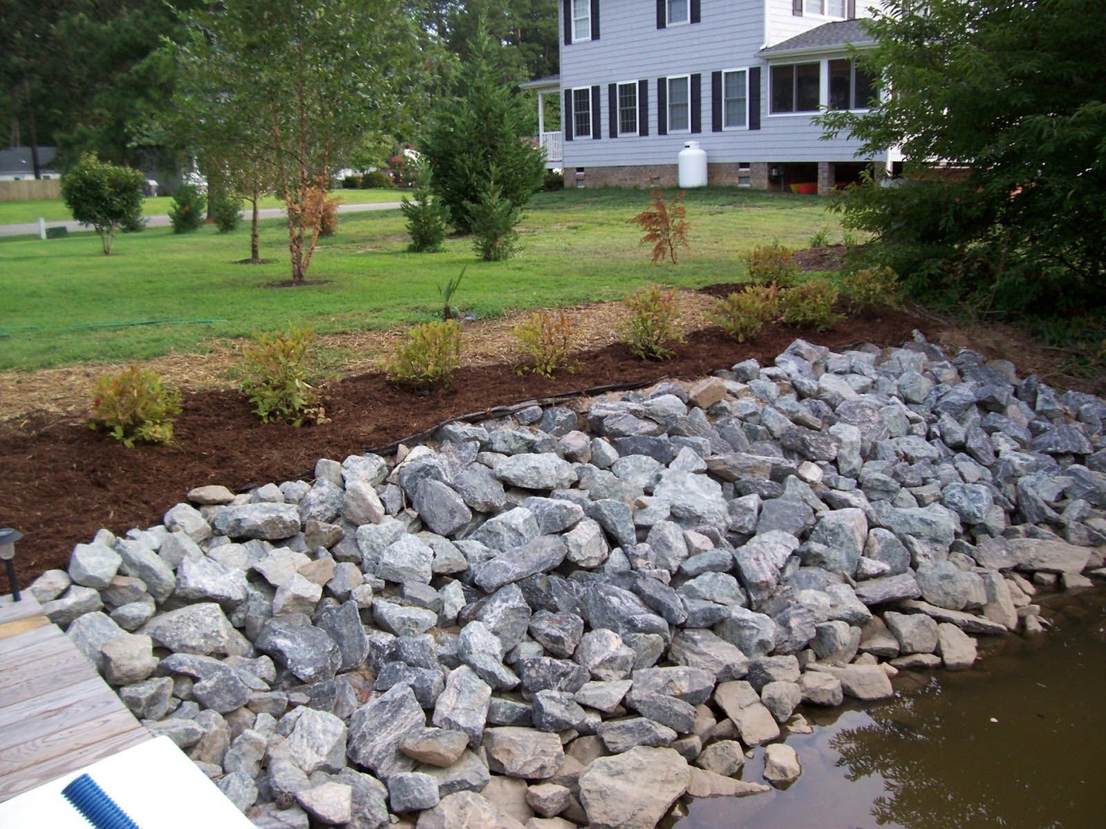 Rip rap stones lining a shoreline bank for erosion control