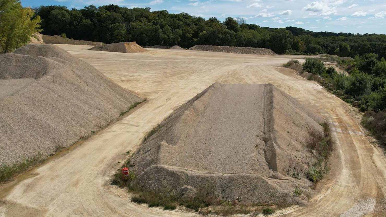 Windrows of gray crushed gravel structural fill material