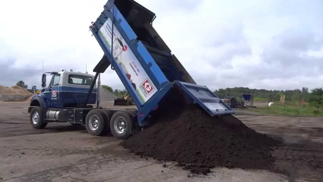 Dump truck dropping a rock load
